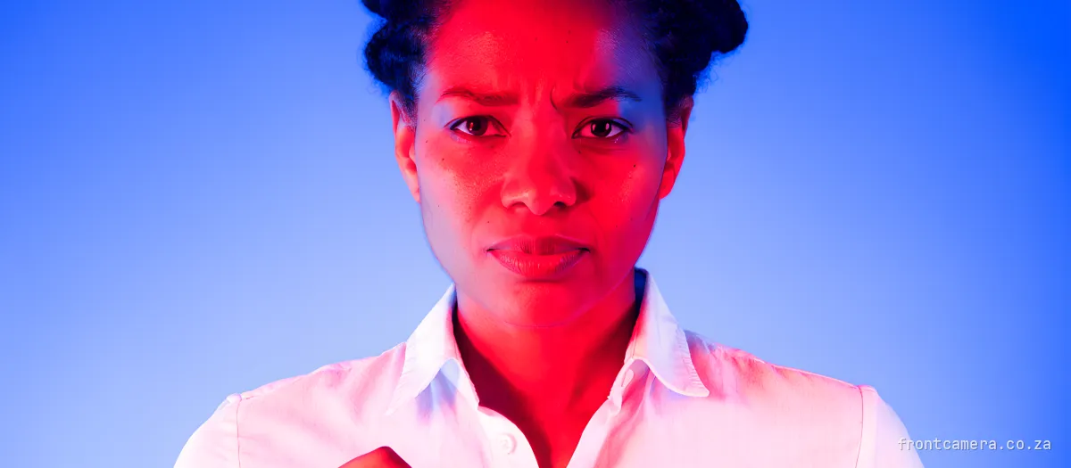 A South African marketing manager in a crisp shirt holding a clipboard against her chest, decisive expression